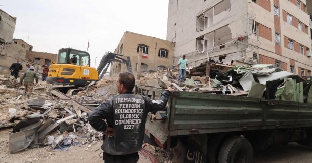A digger removes the debris following damage to a residential building in the Iranian capital Tehran, March 15, 2026. (AFP File Photo)