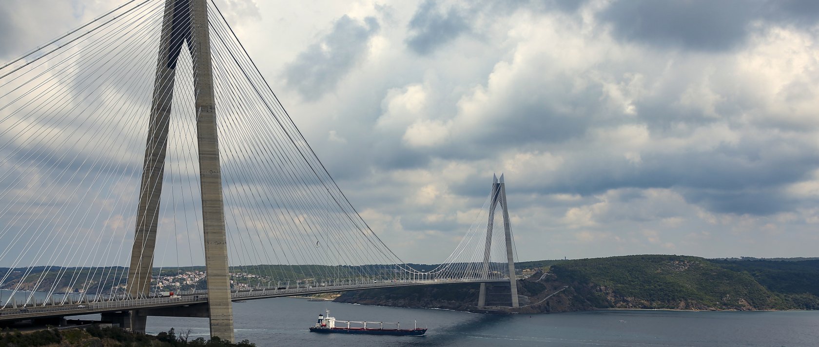 The Sierra Leone-flagged cargo ship Razoni sails under Yavuz Sultan Selim Bridge at the entrance of the Bosphorus Strait in Istanbul, Türkiye, Aug. 3, 2022. (AP Photo)
