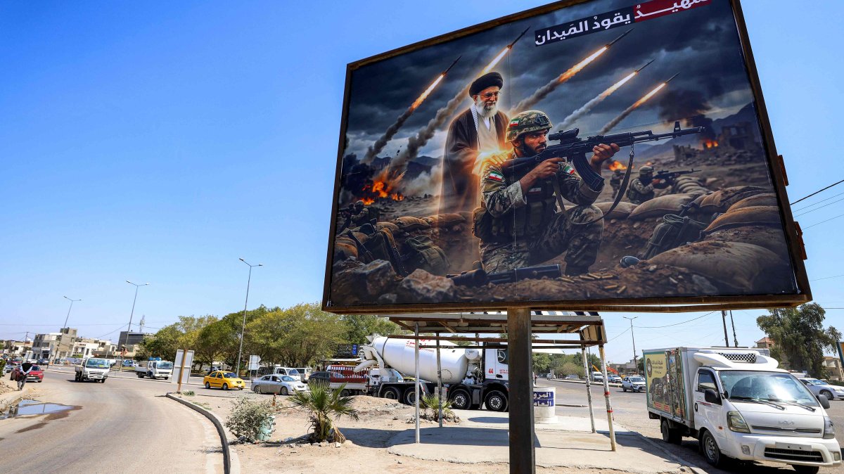 A billboard depicting Ayatollah Ali Khamenei, Iran's late supreme leader who was killed in a U.S.-Israeli strike in Tehran, is displayed along a road in the Ameriyah neighborhood, Baghdad, Iraq, March 18, 2026. (AFP Photo)