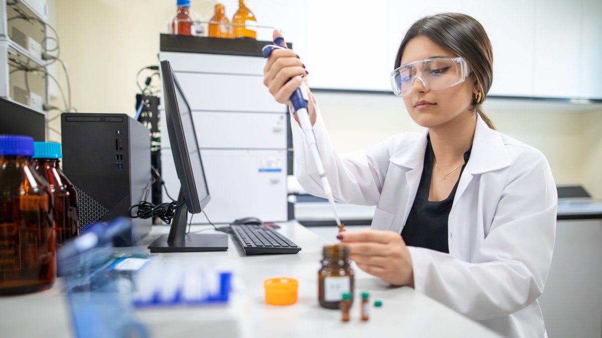 A female researcher wearing protective goggles uses a micropipette to handle liquid samples in a laboratory, Istanbul, Türkiye, April 12, 2023. (Shutterstock Photo) 