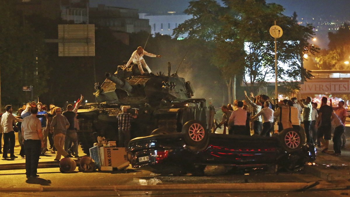 People try to stop a tank commanded by putschists, Ankara, Türkiye, July 16, 2016. (AP Photo)