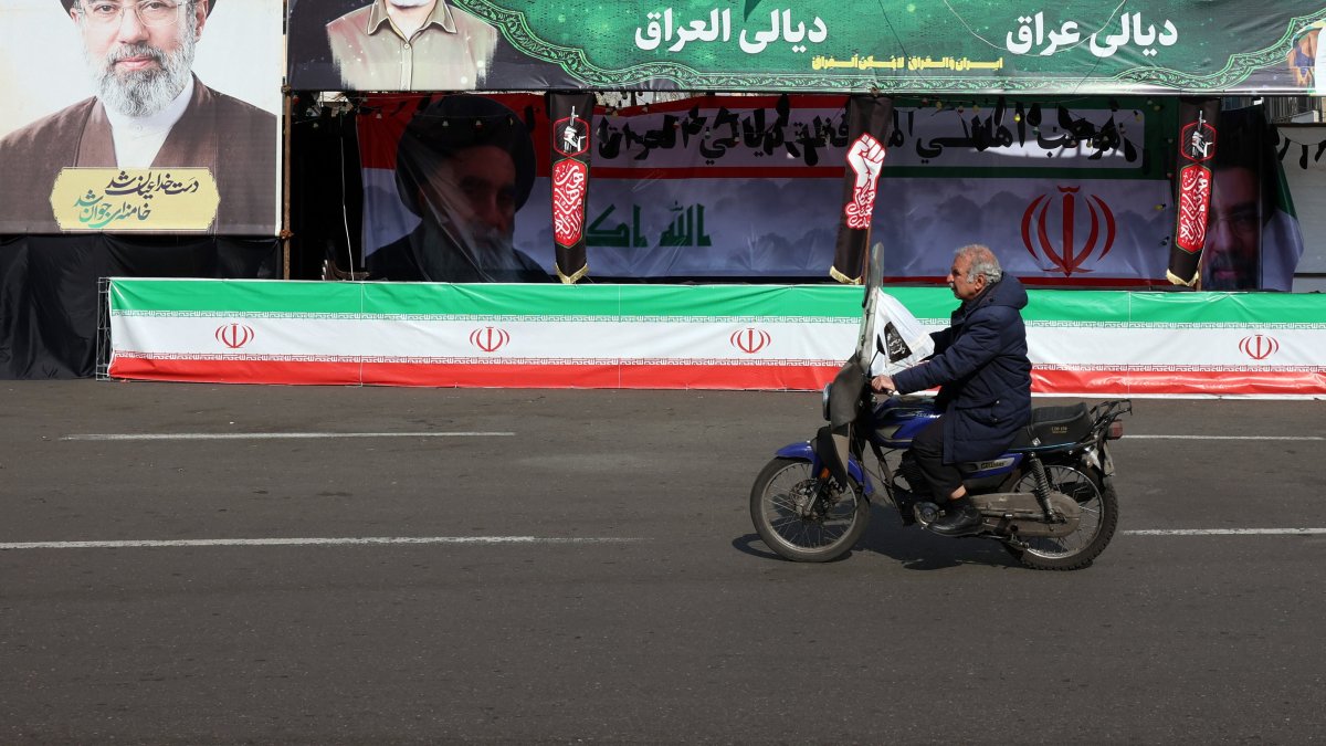 A man drives a motorcycle past billboards of Iranian Supreme Leader Ayatollah Mojtaba Khamenei in a street in Tehran, Iran, March 31, 2026. (EPA Photo)