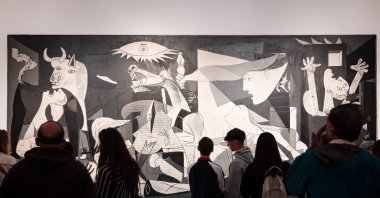 Visitors look at the "Guernica" oil painting by Spanish artist Pablo Picasso at Reina Sofia Museum, Madrid, Spain, March 25, 2024. (Shutterstock Photo)