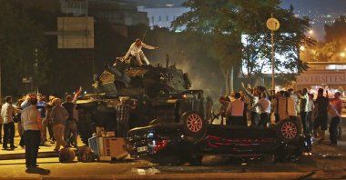 People try to stop a tank commanded by putschists, Ankara, Türkiye, July 16, 2016. (AP Photo)