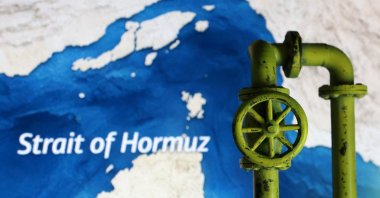 A map showing the Strait of Hormuz and a 3D printed oil pipeline are seen in this illustration taken on March 23, 2026. (Reuters Photo)