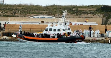 In this photo provided by Mediterranea Saving Humans, an Italian Coast Guard rescue boat at dock in the southern Italian island of Lampedusa, disembarks survivors and bodies rescued from a dinghy filled with migrants at about 80 nautical miles from the island of Lampedusa, Italy, Wednesday, April 1, 2026. (Mediterranea Saving Humans via AP)
