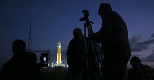 News photographers set up remote cameras near NASA's massive Artemis II Space Launch System (SLS) rocket and Orion spacecraft at Launch Pad 39B before sunrise at the Kennedy Space Center in Cape Canaveral, Florida, U.S., March 31, 2026. (AFP Photo)