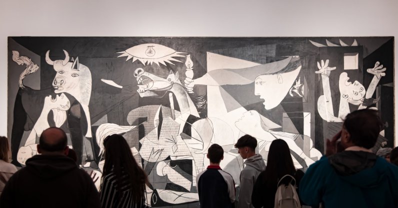 Visitors look at the "Guernica" oil painting by Spanish artist Pablo Picasso at Reina Sofia Museum, Madrid, Spain, March 25, 2024. (Shutterstock Photo)