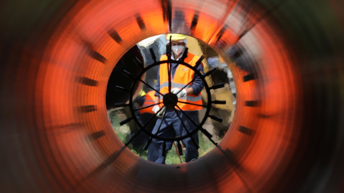 Workers are seen through a pipe at a construction site on the extension of Russia's TurkStream gas pipeline in Letnitsa, Bulgaria, June 1, 2020. (Reuters Photo)