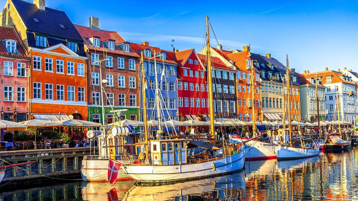 A view of Old Nyhavn harbor with ships and colorful buildings, Old Town, Copenhagen, Denmark. (Shutterstock Photo)
