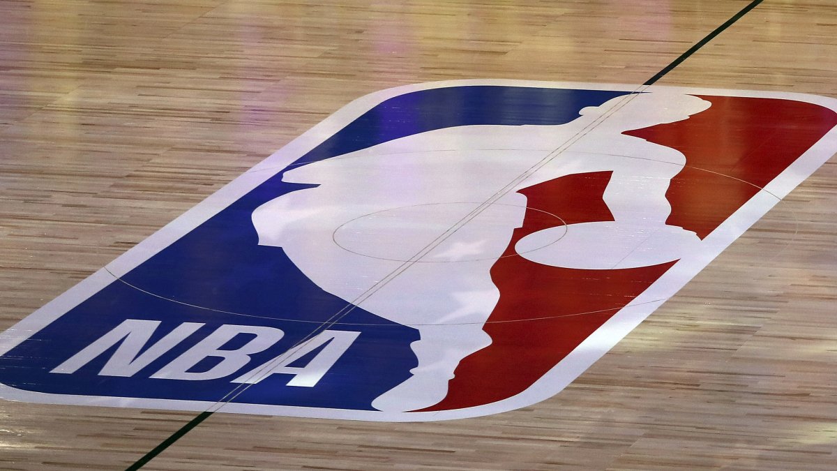 An NBA logo is seen at center court prior to an NBA basketball game between the Los Angeles Clippers and the Los Angeles Lakers, Lake Buena Vista, U.S., July 30, 2020. (AP Photo)
