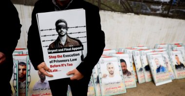 A man holds a sign as Palestinians take part in a protest against the execution of the Israeli death penalty law for Palestinians convicted of lethal attacks, Ramallah, the Israeli-occupied West Bank, Palestine, March 31, 2026. (Reuters Photo)