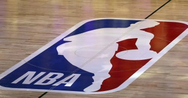 An NBA logo is seen at center court prior to an NBA basketball game between the Los Angeles Clippers and the Los Angeles Lakers, Lake Buena Vista, U.S., July 30, 2020. (AP Photo)