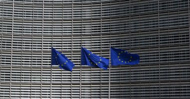 This photograph shows European Union flags outside the EU Commission headquarters in Brussels, March 16, 2026. (AFP Photo)