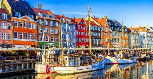 A view of Old Nyhavn harbor with ships and colorful buildings, Old Town, Copenhagen, Denmark. (Shutterstock Photo)
