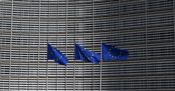 This photograph shows European Union flags outside the EU Commission headquarters in Brussels, March 16, 2026. (AFP Photo)