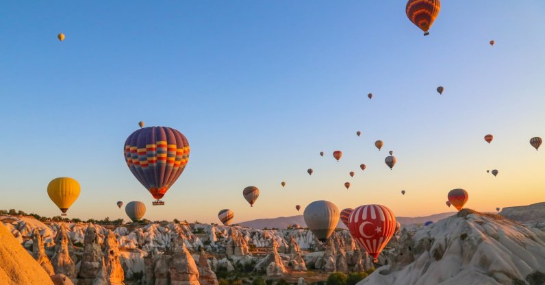 An aerial view of colorful hot air balloons, Cappadocia, Türkiye. (Shutterstock Photo)