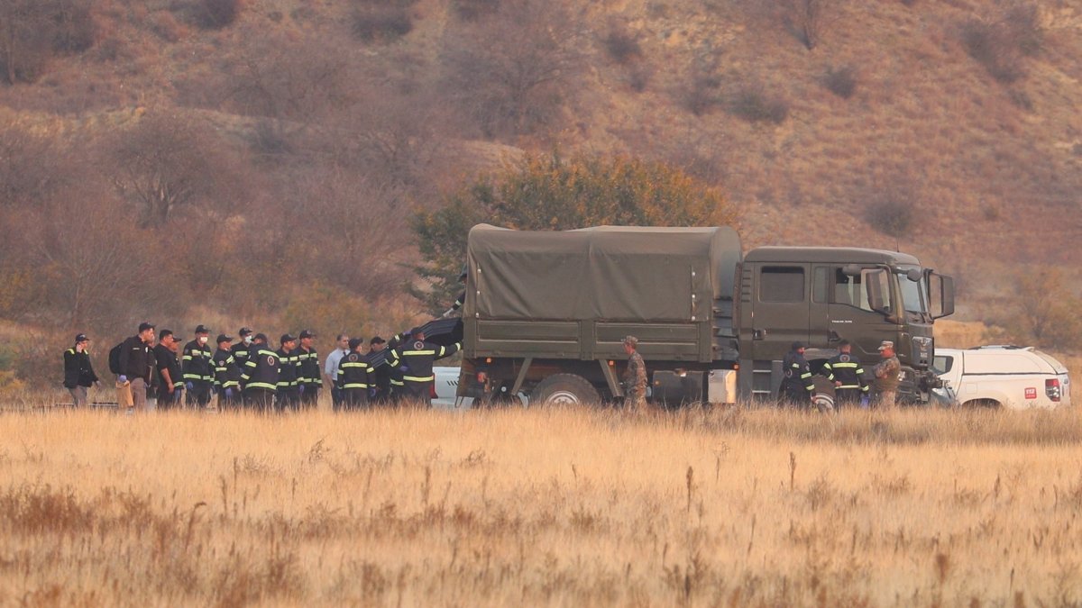 Members of emergency services work at the site of the Turkish C-130 military cargo plane crash near the Azerbaijani border, Sighnaghi municipality, Georgia, Nov. 12, 2025. (Reuters Photo)