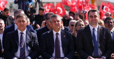 CHP leader Özgür Özel (C) attends a municipal ceremony, accompanied by Izmir Mayor Cemil Tugay (L) in western Izmir province, Türkiye, April 2, 2026. (AA Photo)