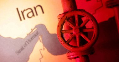 A map showing the Strait of Hormuz and Iran is seen behind a 3D printed oil pipeline in this illustration taken on June 22, 2025. (Reuters Photo)