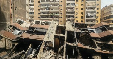 A photograph shows a collapsed building at the site of an overnight Israeli airstrike in the Haret Hreik neighbourhood of Beirut’s southern suburbs, April 3, 2026. (AFP Photo)