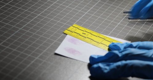 Investigators review DNA analysis documents while re-examining a 15-year-old murder, Antalya, Türkiye, April 3, 2026. (IHA Photo)