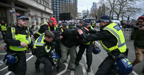 Police arrest a protester (C-in black) for not removing a face covering during an annual protest held by pro-Palestinian group Al-Quds, central London, U.K., March 15, 2026. (AFP Photo)