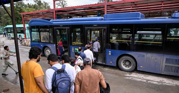 Passengers queue to board a government bus at a bus stop in Islamabad, April 3, 2026. (AFP Photo)