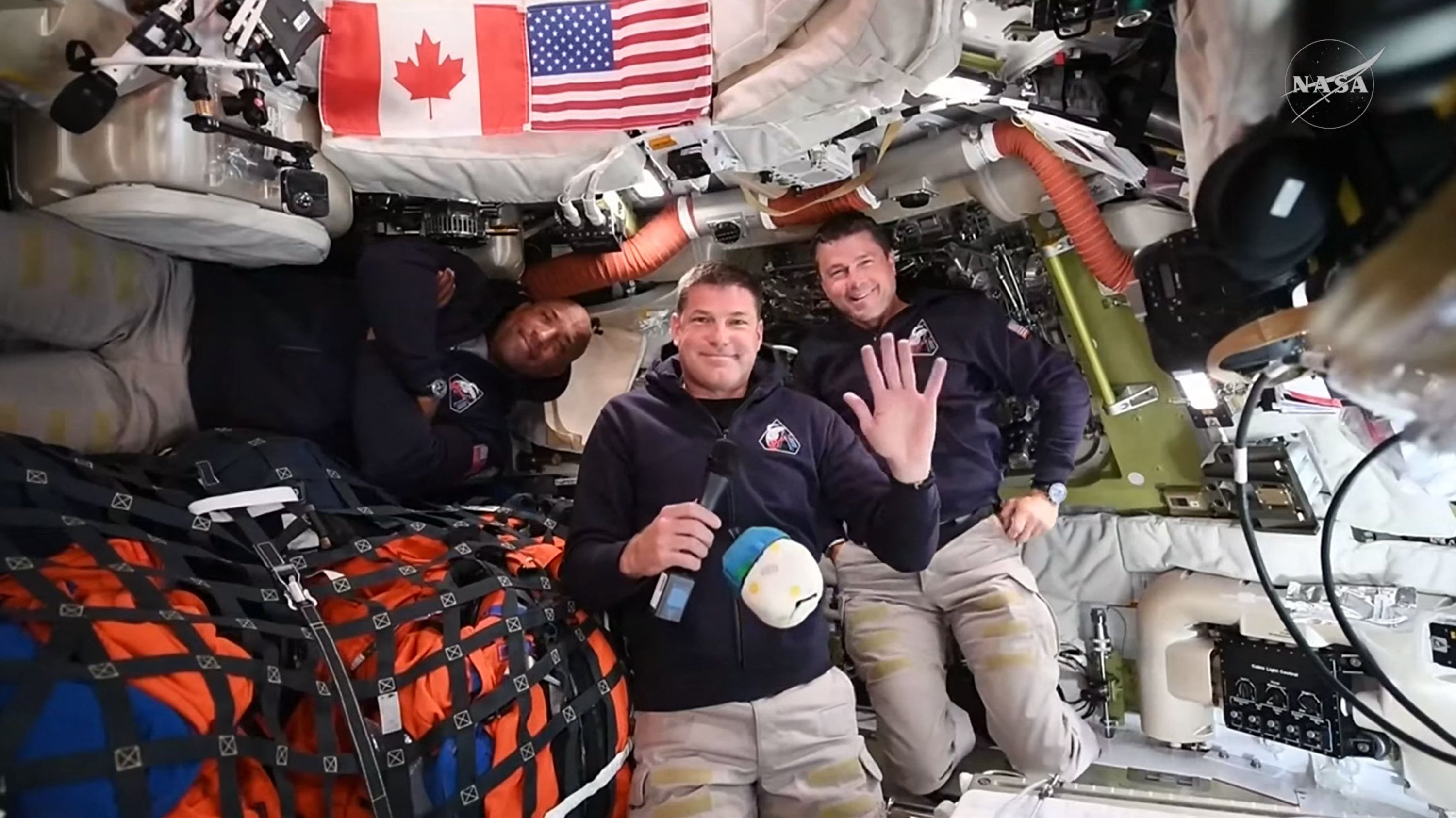 This screengrab from a NASA live broadcast video shows (L-R) NASA astronaut and Artemis II pilot Victor Glover, Canadian Space Agency astronaut Artemis II Mission Specialist Jeremy Hansen and NASA astronaut and Artemis II Commander Reid Wiseman during a press call as they travel to the Moon in the Orion spacecraft, April 3, 2026. (AFP Photo)