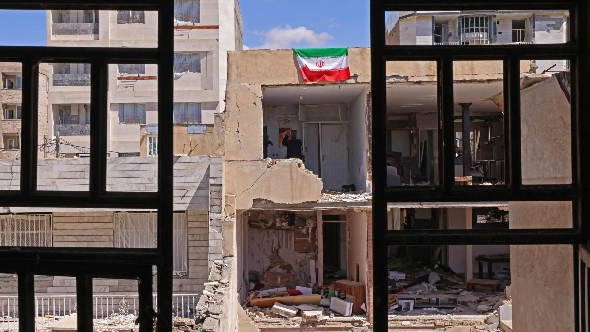 An Iranian flag is seen on a residential building that was damaged by recent strikes at Vahdat town in Karaj, southwest of Tehran, Iran, April 3, 2026. (AFP Photo)
