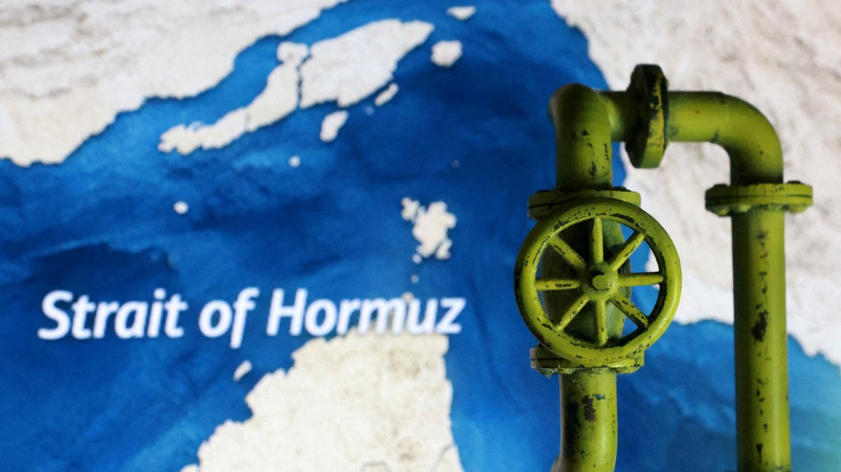 A map showing the Strait of Hormuz and a 3D-printed oil pipeline are seen in this illustration, March 23, 2026. (Reuters Photo)