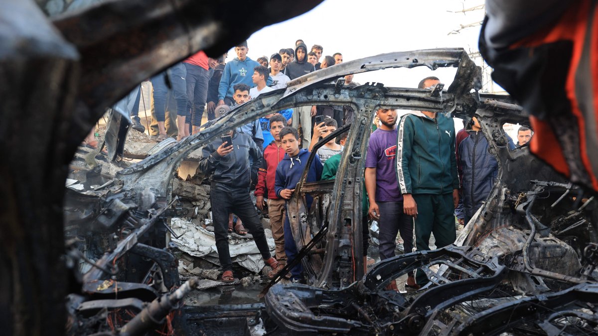 Palestinians inspect a vehicle targeted by an Israeli strike in Maghazi camp for Palestinian refugees in the central Gaza Strip, Palestine, April 4, 2026. (AFP Photo)