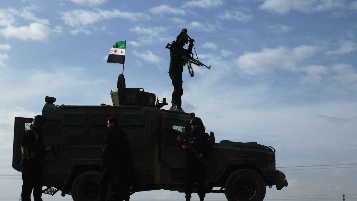 A vehicle pauses as a convoy of Syria's Interior Ministry forces passes through en route to the town of Qamishli as part of a deal with YPG, Syria, Feb. 3, 2026. (AP Photo)