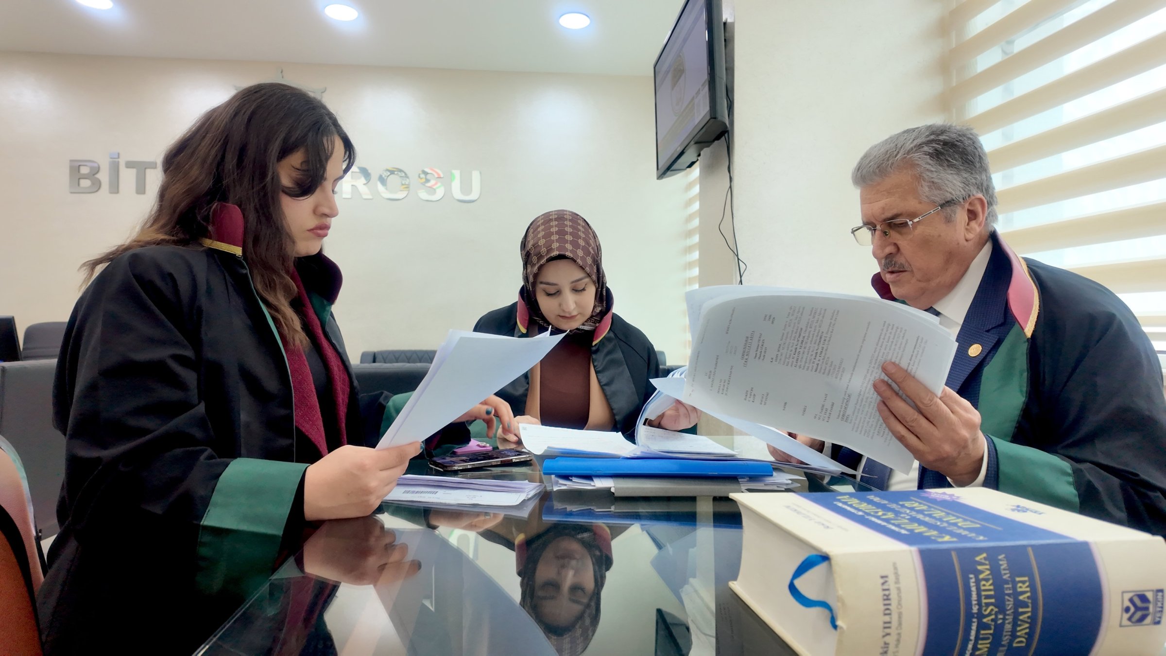 Three lawyers review legal documents, Bitlis, Türkiye, April 1, 2026. (AA Photo)