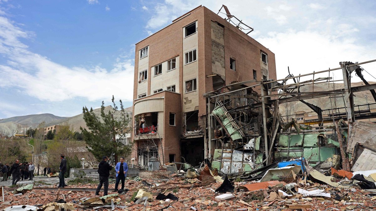 Officials and media gather around the Shahid Beheshti University after it was damaged in U.S.-Israeli airstrikes, in Tehran, Iran, April 4, 2026. (AFP Photo)