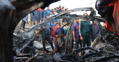 Palestinians inspect a vehicle targeted by an Israeli strike in Maghazi camp for Palestinian refugees in the central Gaza Strip, Palestine, April 4, 2026. (AFP Photo)