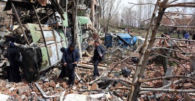 Officials and media representatives gather around the damaged building of Shahid Beheshti University following a strike, Tehran, Iran, April 4, 2026. (AFP Photo)