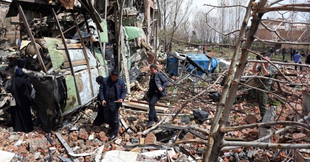 Officials and media representatives gather around the damaged building of Shahid Beheshti University following a strike, Tehran, Iran, April 4, 2026. (AFP Photo)