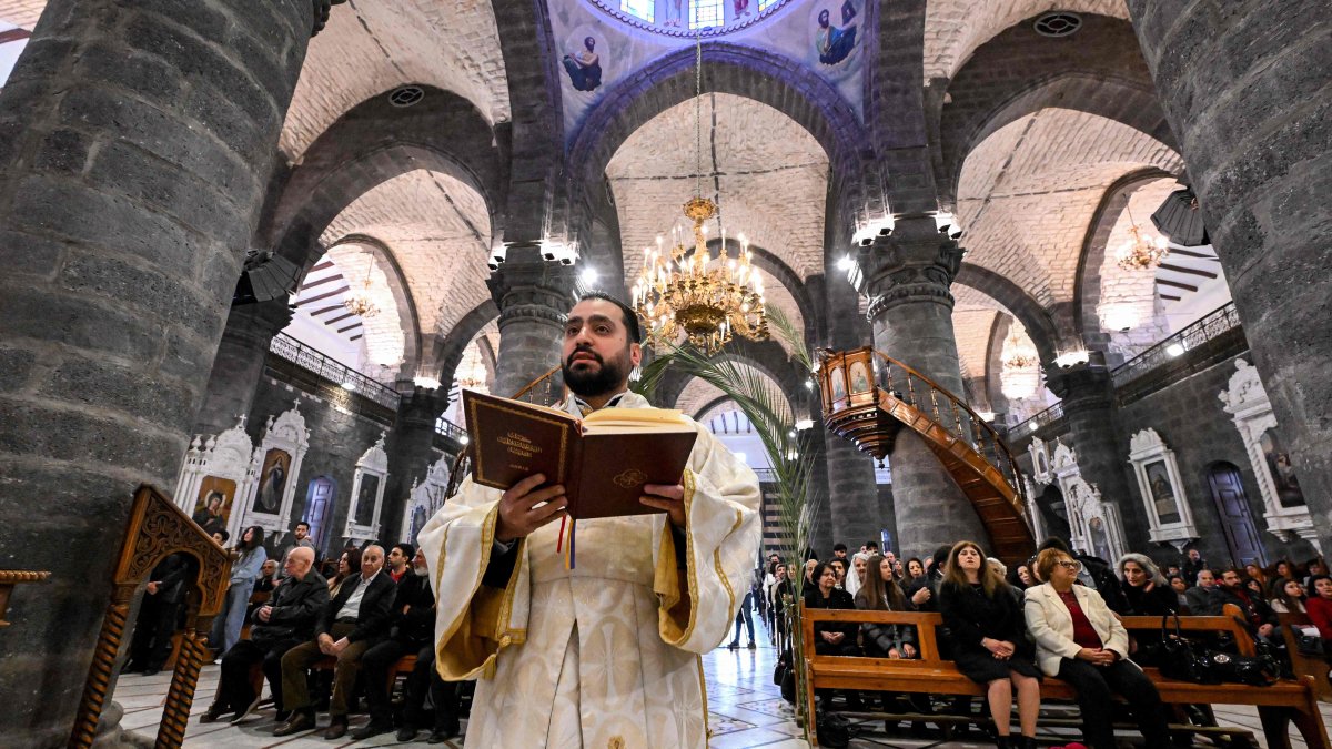 Faithful attend the Palm Sunday service at the Cathedral of Our Lady of Dormition, headquarters of the Melkite Greek Catholic Patriarchate, in Damascus, Syria, March 29, 2026. (AFP Photo)