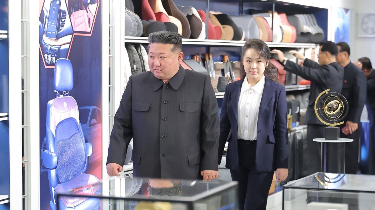 This undated photo shows North Korean leader Kim Jong Un (L) and his daughter Kim Ju Ae inspecting an automobile technical service center in Pyongyang, North Korea.