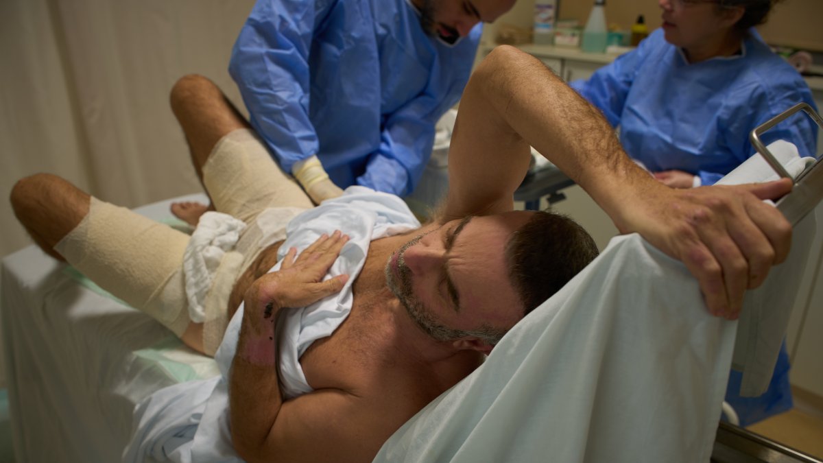 Mohammad Qubaisi, with burn wounds from an Israeli airstrike on southern Lebanon, undergoes surgery by Dr. Mohammed Ziara, left, and his team, at the Sidon Government Hospital, Sidon, Lebanon, April 2, 2026. (AP Photo)