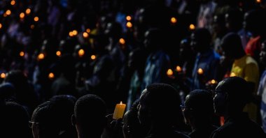 Community members listen to the testimony of a survivor during a vigil event at the BK arena as Rwanda commemorates the 31st anniversary of the Tutsi genocide, Kigali, Rwanda, April 7, 2025. (Getty Images Photo)