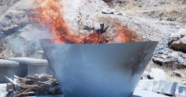 A pit filled with weapons is set on fire by members of terrorist group PKK during a ceremony in Sulaimaniyah, Iraq, July 11, 2025. (AFP Photo)