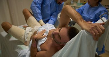 Mohammad Qubaisi, with burn wounds from an Israeli airstrike on southern Lebanon, undergoes surgery by Dr. Mohammed Ziara, left, and his team, at the Sidon Government Hospital, Sidon, Lebanon, April 2, 2026. (AP Photo)