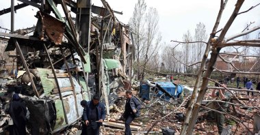 Officials and media representatives gather around the damaged building of the Shahid Beheshti University following a strike, Tehran, Iran, April 4, 2026. (AFP Photo)