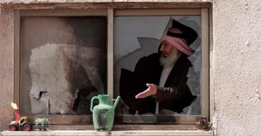 An elderly Palestinian man stands inside a house that was destroyed following an Israeli settler attack on the outskirts of al-Lubban ash-Sharqiya village, south of Nablus in the occupied West Bank, Palestine, April 6, 2026. (AFP Photo)