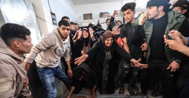 Family members mourn over the body of a Palestinian victim at the Al-Aqsa Martyrs Hospital in Deir al-Balah following an Israeli strike on the Al-Maghazi refugee camp in the central Gaza Strip, April 6, 2026. (AFP Photo)
