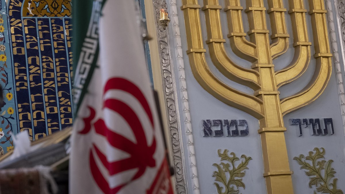 An Iranian flag is pictured alongside a Menorah during a gathering at a synagogue in downtown Tehran, Iran, Oct. 30, 2023. (Getty Images)