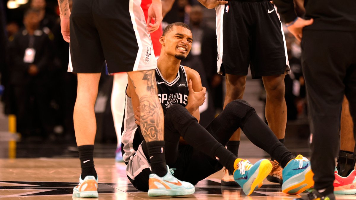 San Antonio Spurs' Victor Wembanyama grabs his left arm after an injury during a game against the Philadelphia 76ers in the first half at Frost Bank Center, San Antonio, U.S., April 6, 2026. (AFP Photo)