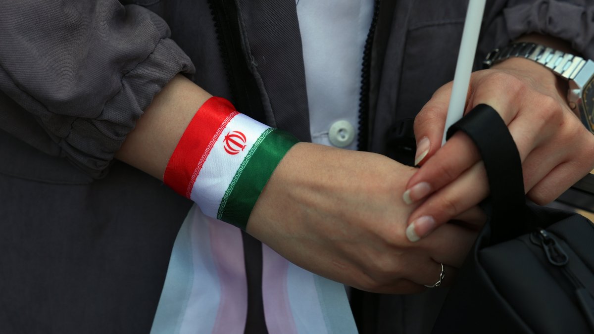 An Iranian nurse wears Iran's national flags on her hand during a protest against U.S.-Israeli attacks in Tehran, Iran, April 6, 2026. (EPA Photo)